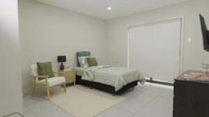 Leumeah SIL housing - bedroom with armchair