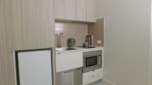 Leumeah SIL housing - kitchenette with fridge, microwave and cooktop